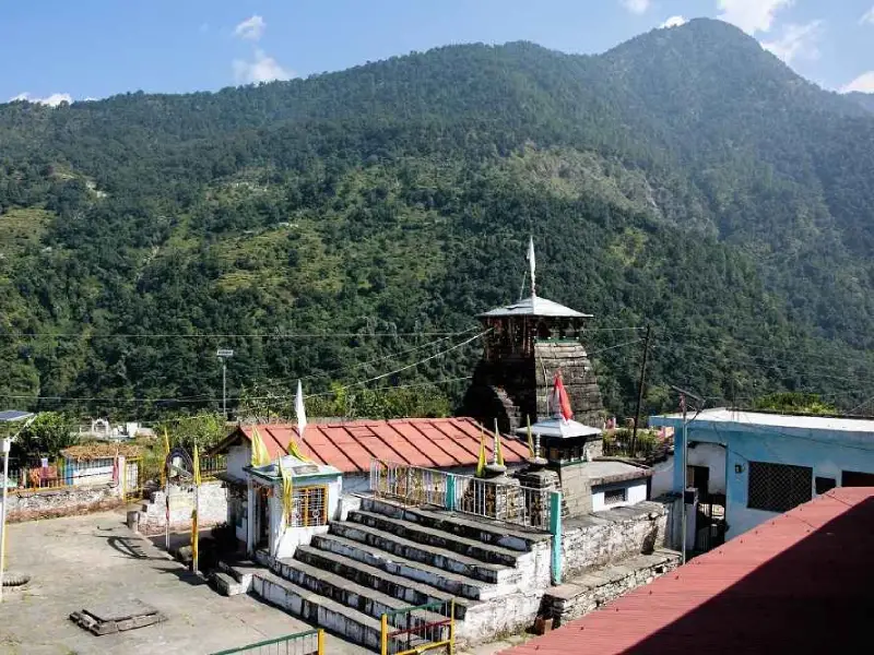 a view if Makkumath Temple with mountain and trees in the background